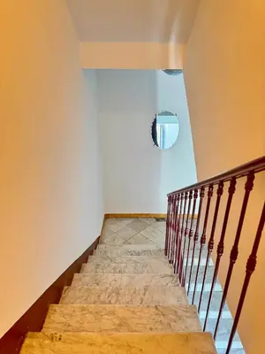 a staircase in a house with a mirror on the wall at Cozy studio sur la promenade in Nice