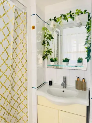 a bathroom with a sink and a mirror at Cozy studio sur la promenade in Nice