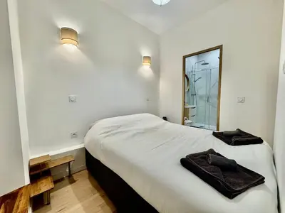 a bedroom with a bed with two towels on it at Charming Studio in the Heart of Nice in Nice