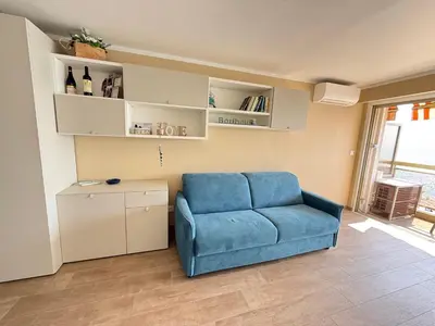 a blue couch in a living room with a window at Azur Promenade in Nice