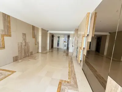 a hallway in a building with paintings on the walls at Azur Promenade in Nice