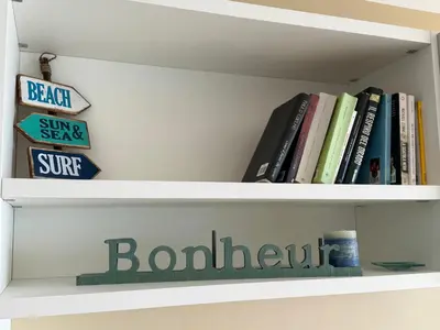 a shelf with books and a sign on it at Azur Promenade in Nice