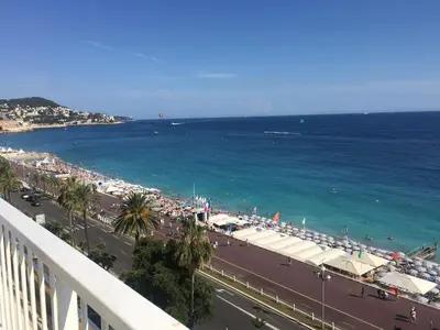 a view of the ocean from the balcony of a building at Studio et ses deux piscines in Nice