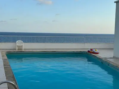 a swimming pool on a building with the ocean in the background at Studio et ses deux piscines in Nice