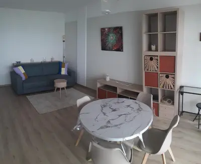 a living room with a table and chairs and a couch at Stella Maris in Cagnes-sur-Mer