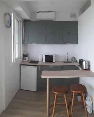 a kitchen with a table and two stools in it at Stella Maris in Cagnes-sur-Mer