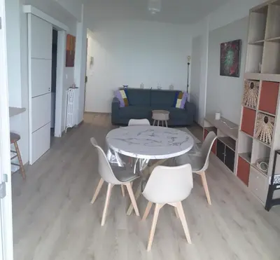 a living room with a table and chairs and a couch at Stella Maris in Cagnes-sur-Mer