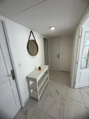 a white room with a mirror and a table at Magnifique 3 pièces à 100m de la mer in Nice