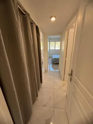 a hallway with a row of curtains in a room at Magnifique 3 pièces à 100m de la mer in Nice