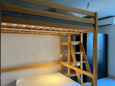 a bunk bed with a ladder in a room at Studio tout équipé in Nice