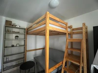 a bunk bed in a room with a ladder at Studio tout équipé in Nice
