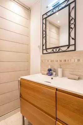 a bathroom with a sink and a mirror at Charming flat, fully equipped, air conditioning, beach only 300m - LA LOGE in Nice