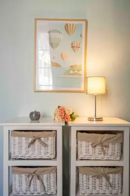 a table with baskets and a lamp and a picture at Charming flat, fully equipped, air conditioning, beach only 300m - LA LOGE in Nice