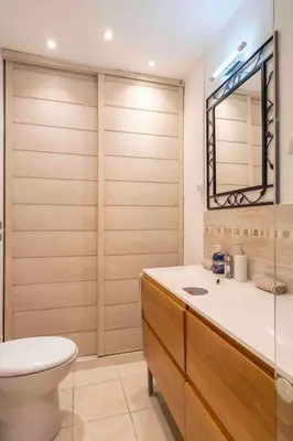 a bathroom with a toilet and a sink and a mirror at Charming flat, fully equipped, air conditioning, beach only 300m - LA LOGE in Nice