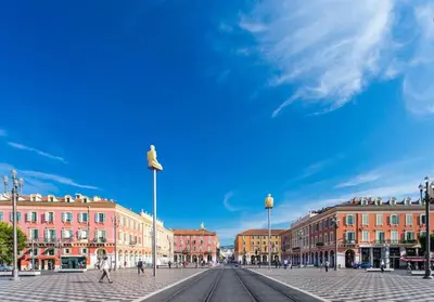a city street with buildings and a blue sky at Charming flat, fully equipped, air conditioning, beach only 300m - LA LOGE in Nice