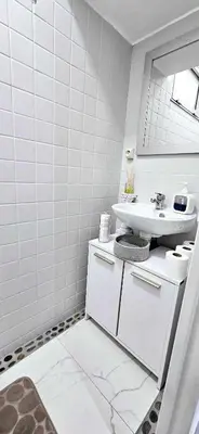 a white bathroom with a sink and a mirror at Top Floor with Sea View, Clim and Veranda in Nice