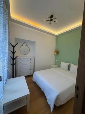 a bedroom with two beds and a ceiling fan at 2P place massena in Nice