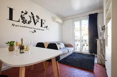 a living room with a couch and a fireplace at Suite romantique - Carré d'Or Nice proche de la mer in Nice