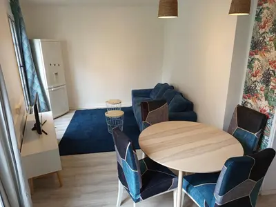 a dining room with a table and chairs at Calme, confortable et bien placé in Nice