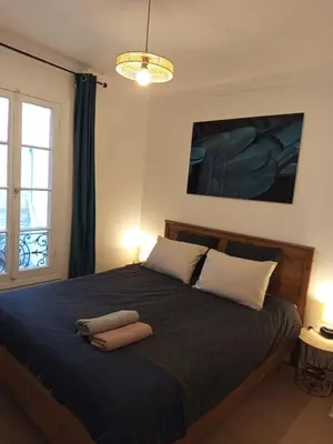 a bedroom with a bed with two towels on it at Calme, confortable et bien placé in Nice