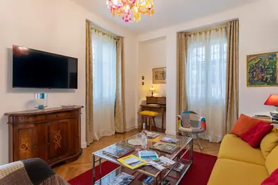 a living room with a couch and a tv at LE ROYAL AP4456 by Riviera Holiday Homes in Nice