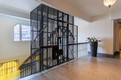 a stairwell with a black iron railing at LE ROYAL AP4456 by Riviera Holiday Homes in Nice