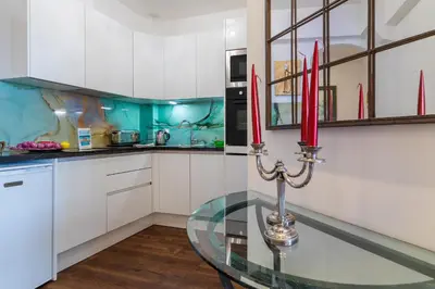 a kitchen with a glass table with red candles at LE ROYAL AP4456 by Riviera Holiday Homes in Nice