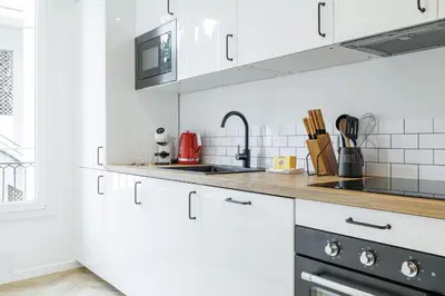 a kitchen with white cabinets and a sink at Large & Confort 2 Bdr Renovated in Nice
