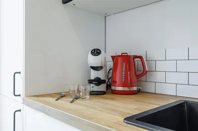 a kitchen counter with a red tea kettle and glasses at Large & Confort 2 Bdr Renovated in Nice