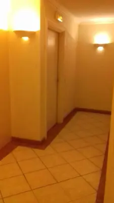 an empty room with a tile floor and two lights at Studio 200m mer et promenade des anglais in Nice