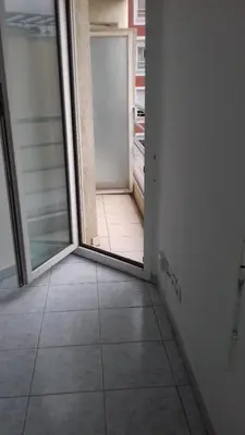 an empty room with a door and a tile floor at Studio 200m mer et promenade des anglais in Nice