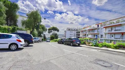 a street with cars parked on the side of the road at Residence les Lauriers in Nice