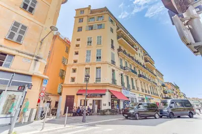 two cars parked in front of a tall building at LE PAIROLIERE AP4461 by Riviera Holiday Homes in Nice