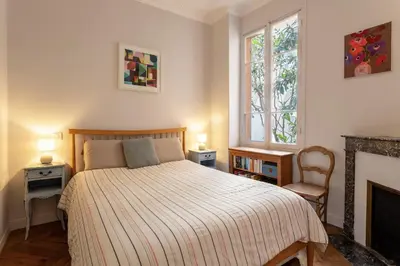 a bedroom with a bed and a fireplace at Berlioz Blue AP4458 by Riviera Holiday Homes in Nice