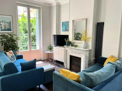 a living room with two blue couches and a fireplace at Berlioz Blue AP4458 by Riviera Holiday Homes in Nice