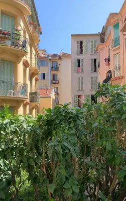 a group of buildings with trees in the foreground at Berlioz Blue AP4458 by Riviera Holiday Homes in Nice