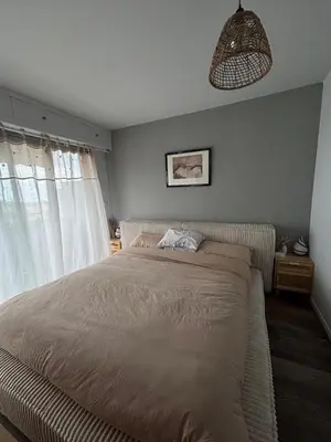 a bedroom with a large bed and a pendant light at Appartement de Tim in Cagnes-sur-Mer