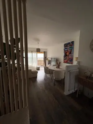 a living room with a couch and a table at Appartement de Tim in Cagnes-sur-Mer