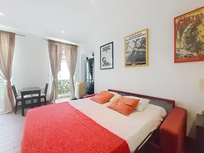 a bedroom with a large bed with a red blanket at Nestor&Jeeves - DOLCE VITA STUDIO - Balcon - Central in Nice