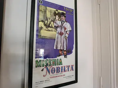 a framed poster of a movie on a wall at Nestor&Jeeves - DOLCE VITA STUDIO - Balcon - Central in Nice
