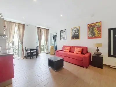 a living room with a red couch and a table at Nestor&Jeeves - DOLCE VITA STUDIO - Balcon - Central in Nice