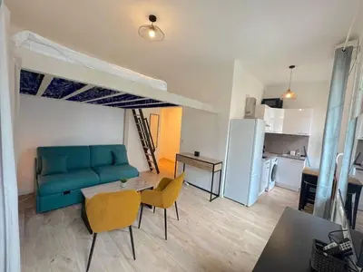 a kitchen with a white refrigerator and a table at ⁂Appartement élégant plage à 100m prom des anglais in Nice