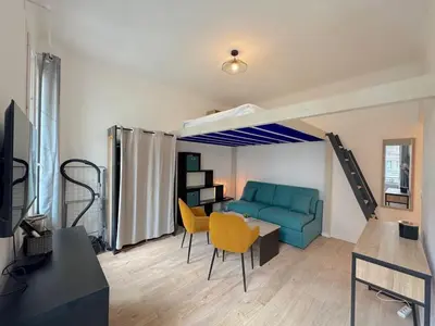 a living room with a blue couch and yellow chairs at ⁂Appartement élégant plage à 100m prom des anglais in Nice