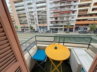 a large bed in a white room with a table at ⁂Appartement élégant plage à 100m prom des anglais in Nice