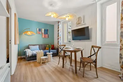 a living room with a table and a couch at Nice Renting - CLEMENCEAU - Riviera Cocoon Calm Elegance Design in Nice