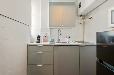 a kitchen with white cabinets and a sink at Nice Renting - CLEMENCEAU - Riviera Cocoon Calm Elegance Design in Nice