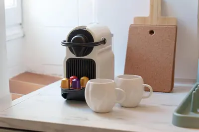 a coffee maker and two cups on a counter at Nice Renting - CLEMENCEAU - Riviera Cocoon Calm Elegance Design in Nice