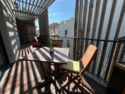 a balcony with a table and two chairs on a deck at 3 pièces central au pied de la promenade du paillon in Nice