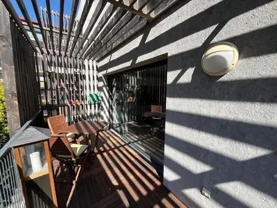 a balcony with a table and chairs on a building at 3 pièces central au pied de la promenade du paillon in Nice