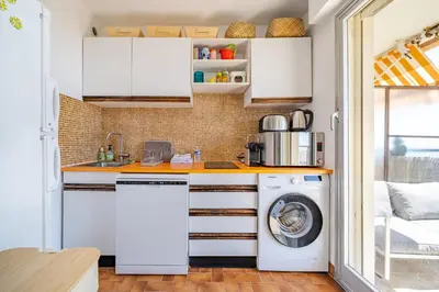 a kitchen with a washer and dryer at Studio Vue mer Parking Clim in Nice